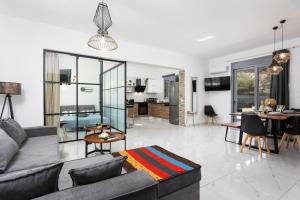 a living room with a couch and a dining room at Villa Livis 2 in Kiotari