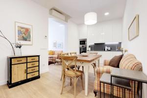 a kitchen and living room with a table and a couch at Opera II in Madrid