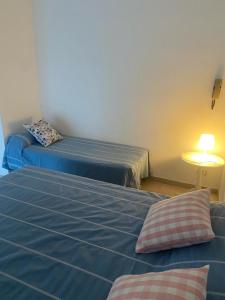 a room with two beds and a table with a lamp at Casa di Anna in Ravenna
