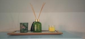 a shelf with a bottle and a candle and a glass at Estudio Fibes-Lux Sevilla in Seville