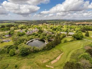 an aerial view of a golf course with a pond at 2 Bed in St. Mellion 87703 in St Mellion