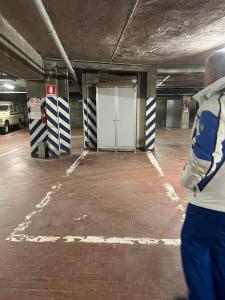 a man walking through an empty parking garage at Gloria Holiday Home Bormio in Bormio