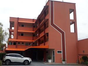 a white car parked in front of a building at Hotel Jovilá in Jaraguá do Sul