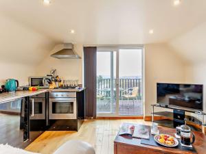 a large kitchen with a view of a balcony at 1 bed in Barnstaple ELLCO in Fremington