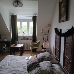 a bedroom with a bed and a window at Le Banellou in Quimper
