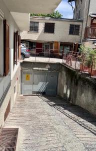 a gate to a building with a parking lot at Gloria Holiday Home Bormio in Bormio