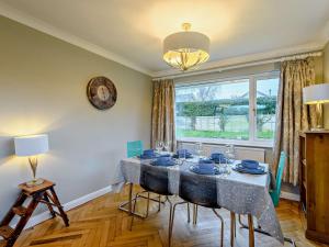 a dining room with a table and a window at 3 Bed in Corfe Castle 86239 in Corfe Castle
