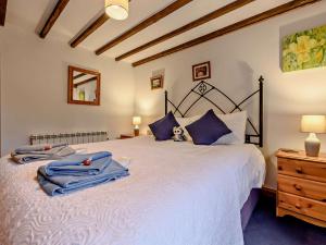 a bedroom with a bed with blue towels on it at 2 Bed in Gamblesby 90415 in Kirkoswald