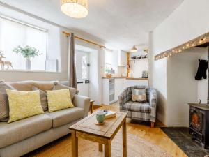 a living room with a couch and a table at 1 bed in Chulmleigh 82389 in Chulmleigh