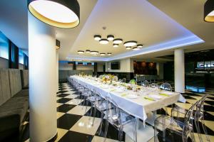 a long dining room with a long table with chairs at Vigo Hotel in Łódź