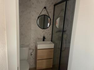 a bathroom with a toilet and a sink and a mirror at Río Genil in Pinos Genil +6 photos