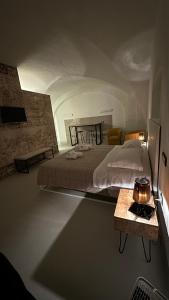 a bedroom with a large bed and a table at Appartamento Pepe in Francavilla Fontana
