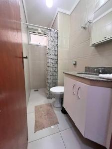 a bathroom with a toilet and a sink and a shower at Made in Roça in Uberlândia