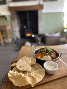 a table with a bowl of soup and some tortilla chips at Redmire Village Pub in Redmire