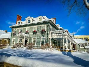 a large house with snow in front of it at 300 Clifton in Minneapolis