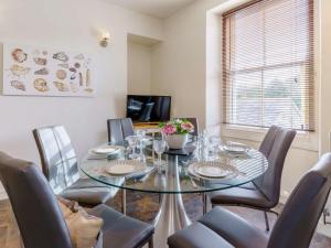 a dining room with a glass table and chairs at 4 Bed in Pembroke 85835 in Pembroke