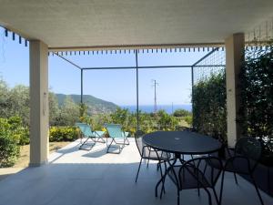 a table and chairs on a patio with a view at Podere Belvedere in Moneglia