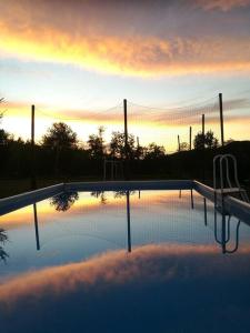 a volleyball court with a volleyball net in the sunset at casa nel verde Cà dla cola in Mombasiglio +27 photos