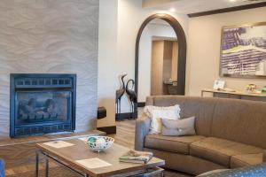 a living room with a couch and a fireplace at Holiday Inn Express Jackson, an IHG Hotel in Jackson