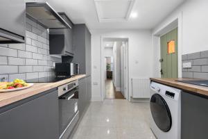 a kitchen with a sink and a dishwasher at Modern Cozy 1 Bedroom Flat in Prime Location in Moseley in Birmingham