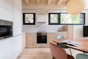 a kitchen with a wooden table and chairs at Exclusivo Dúplex en Salamanca in Madrid