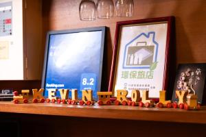 a wooden shelf with a toy train and two pictures at Pine Tree Resort  in Zhushan