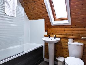 a bathroom with a white toilet and a sink at Macha 3 - Hot Tub-Perth-Pets-Family-Luxury-Cabin in Perth +6 photos