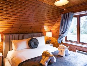 a bedroom with a bed in a log cabin at Macha 3 - Hot Tub-Perth-Pets-Family-Luxury-Cabin in Perth