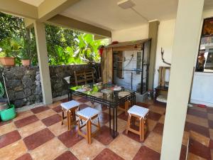 a patio with a table and chairs and a counter at Kowlessur Residence in Surinam