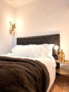 a bedroom with a large bed with a teddy bear on a table at CerezinoFlats-Estúdio Vista Baía in Seixal