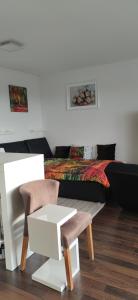 a bedroom with a bed and two chairs and a table at Praha Letňany 168 Free garage parking in Prague