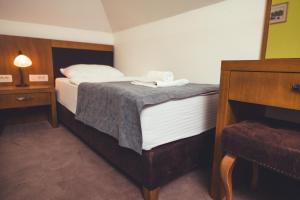 Postel nebo postele na pokoji v ubytování Etno selo Stanišići Hotel Leonida