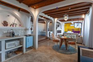 a kitchen and living room with a table and chairs at Pousada Loft da Serra in Lavras Novas