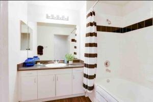 a bathroom with a sink and a tub and a shower at HubLife Your Private Oasis in the Heart of Marina del Rey in Los Angeles
