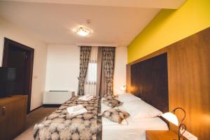 Postel nebo postele na pokoji v ubytování Etno selo Stanišići Hotel Leonida
