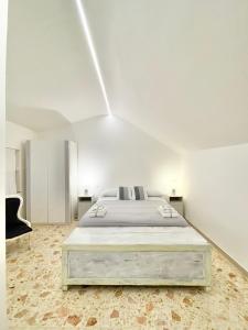 a large white bedroom with a large bed in it at A&A B&B Martina Franca in Martina Franca