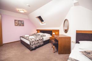 Postel nebo postele na pokoji v ubytování Etno selo Stanišići Hotel Leonida