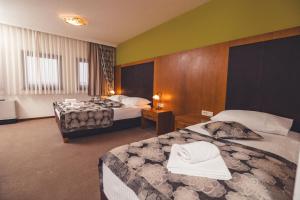 Postel nebo postele na pokoji v ubytování Etno selo Stanišići Hotel Leonida