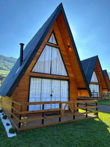 a large wooden house with a pitched roof at Refúgio do Vale Cabanas Exclusivas in Bento Gonçalves