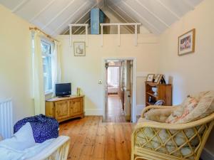 a living room with a couch and a tv at 3 Bed in Lynton 78823 in Lynmouth