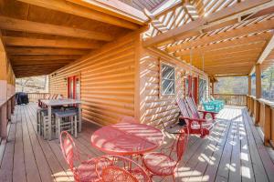 een houten terras met een tafel en stoelen erop bij Waterfront Watauga Lake Home with Private Dock! in Butler
