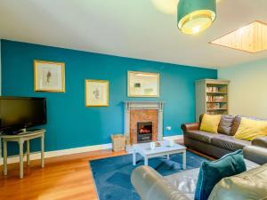 a living room with a couch and a fireplace at 2 Bed in Sanquhar 89403 in Sanquhar