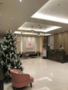 a christmas tree in the middle of a lobby at Family Home in Manila +11 photos