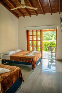 Postel nebo postele na pokoji v ubytování Hotel Campestre La Francesina