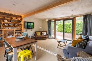 a living room with a blue couch and a table at ‘The Little House on The Priory’ with Hot Tub in Abergavenny