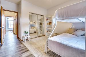 a bedroom with a white bunk bed and a mirror at Elegant Pataskala Home with Hot Tub and Fire Pit! in Pataskala +33 photos