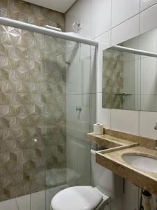 a bathroom with a shower and a toilet and a sink at Hotel Carvalho in Ibiapina