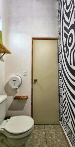 a bathroom with a toilet and a door at MESON AMELIA in San Miguel de Allende