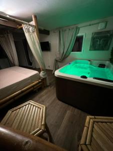 a bedroom with a tub with a bed and a chair at leverest rooms in Marseille