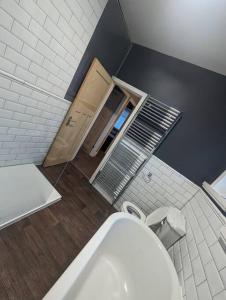 a bathroom with a white toilet in a room at 3 bed home, pool-hot tub & ev charger in Darlington